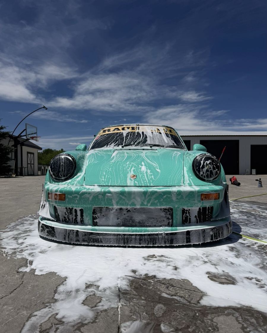 Widebody Porsche 911 covered in snow foam during a full premium mobile detail in Austin